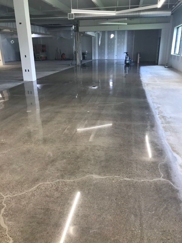 Concrete floor midway through polishing process